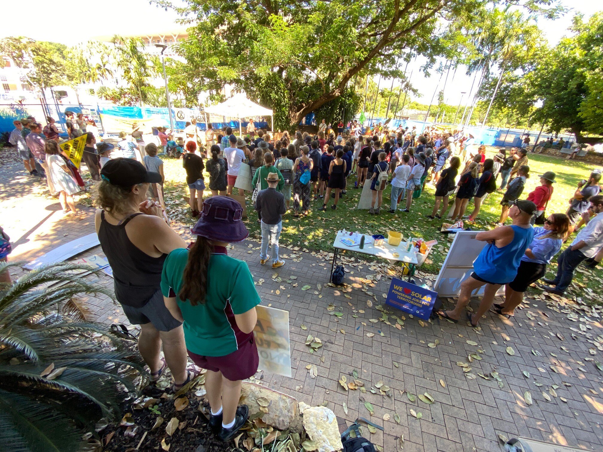 A group of protesters gather at a rally outside NT Parliament in Darwin.
