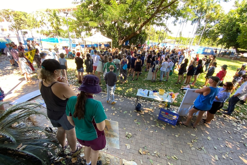 A group of protesters gather at a rally outside NT Parliament in Darwin.