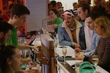 People gather at a small bar in Wollongong.