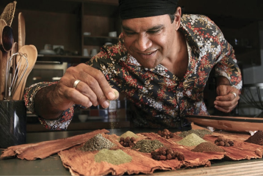 Man demonstrates the herbs and spices of Australian bush tucker