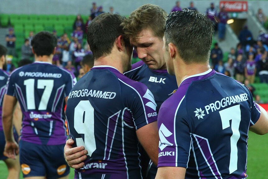 Melbourne's Ryan Hoffman is consoled by Cameron Smith and Cooper Cronk after the elimination final.