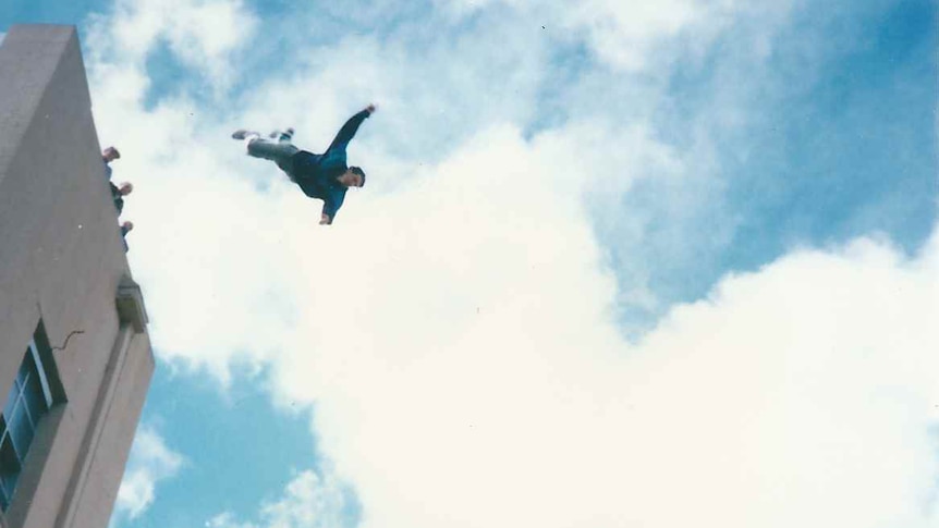 A man freefalling off a six storey building