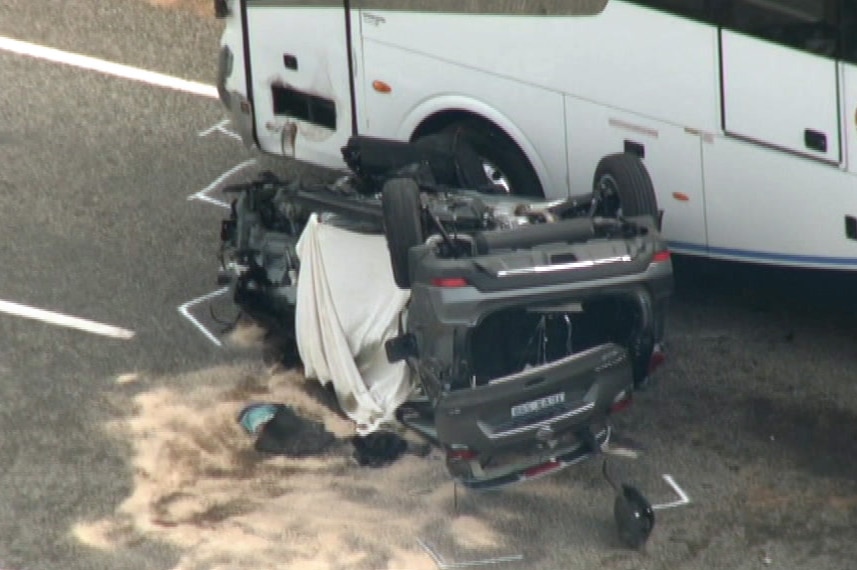 A close-up aerial image of a car lying on its roof next to a bus after a crash on Indian Ocean Drive.