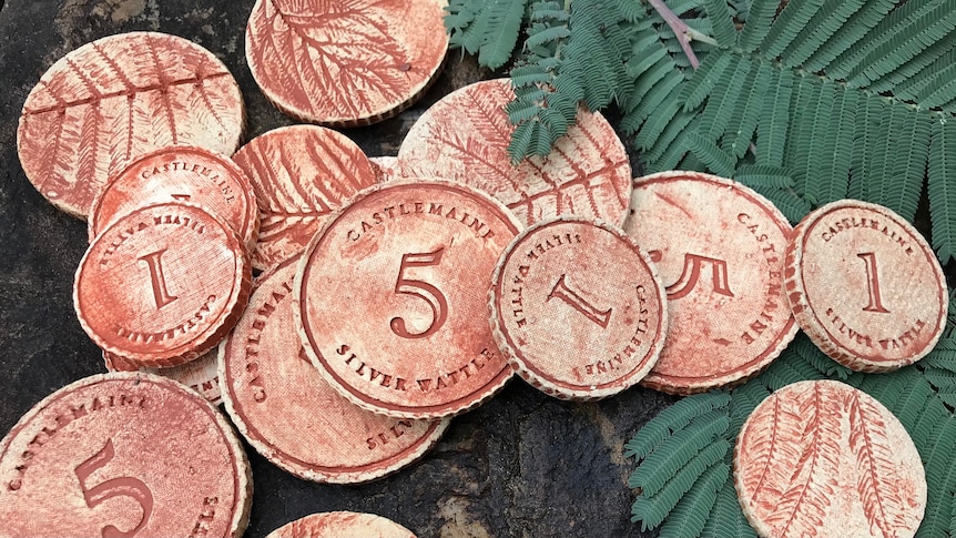 coins made out of clay with 1 and 5's on them, with a wattle print on the back.