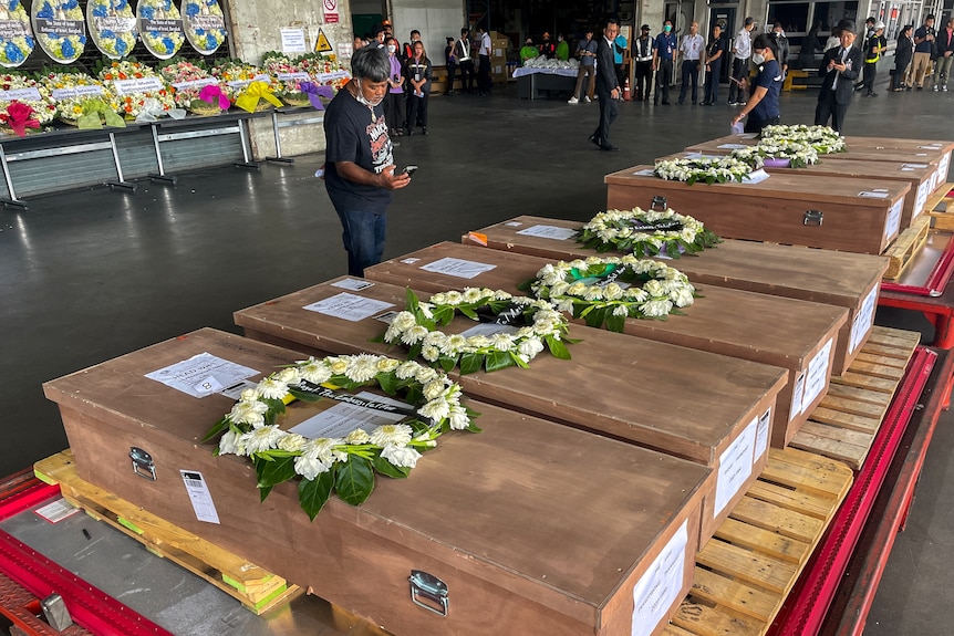 Coffins with wreaths laid on top