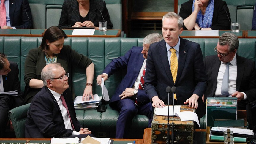 David Coleman speaks at the despatch box, watched on by Prime Minister Scott Morrison
