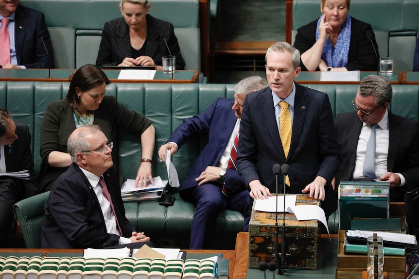 David Coleman speaks at the despatch box, watched on by Prime Minister Scott Morrison