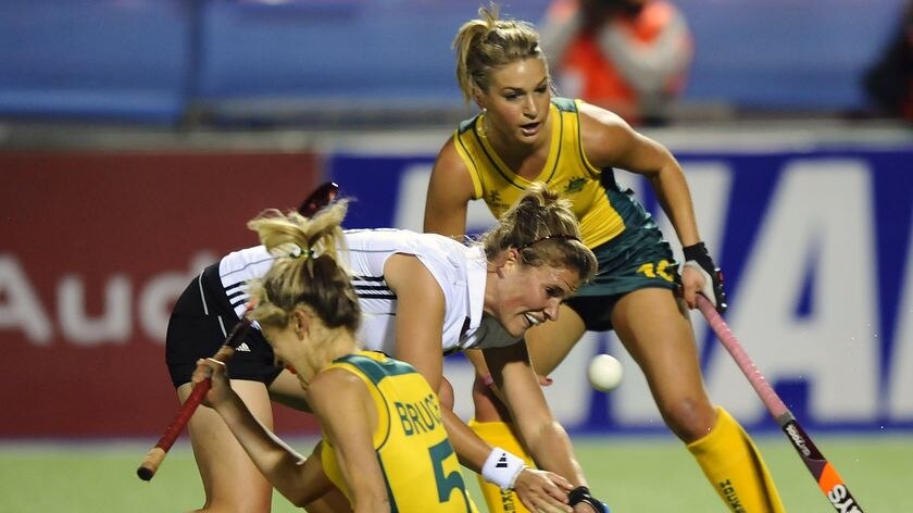 Dumped: Germany's Katharina Otte vies for the ball with Alison Bruce (l) and Kate Hollywood.