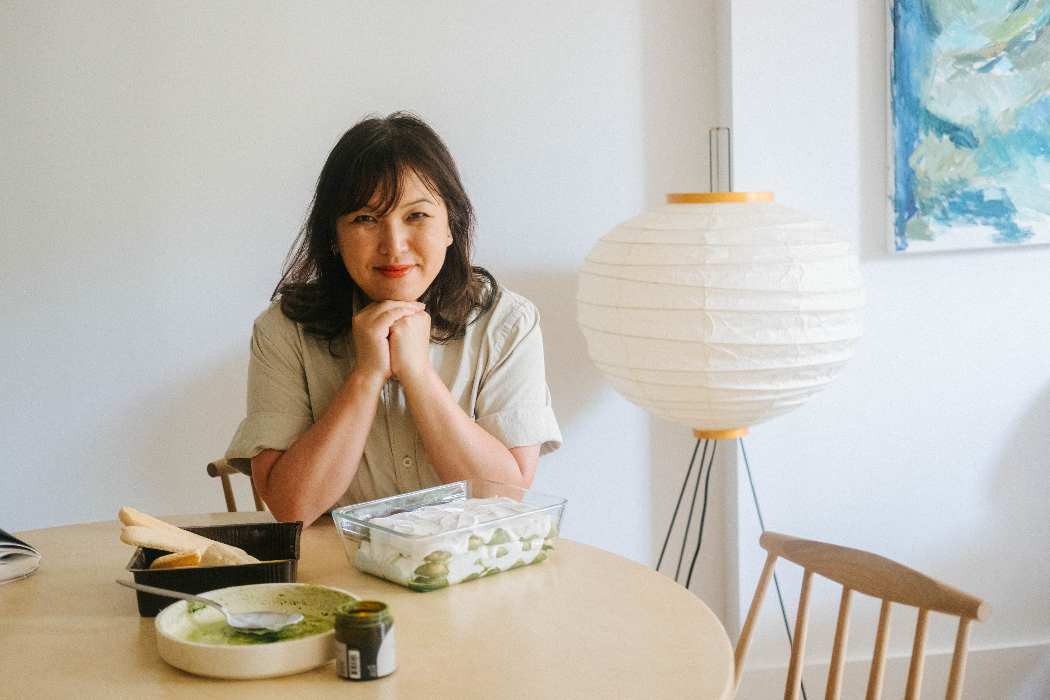Hetty Lui McKinnon sits at her dining table while assembling a matcha tiramisu for Christmas dessert.