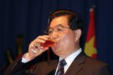 Chinese President Hu Jintao drinks from a wine glass, file photo