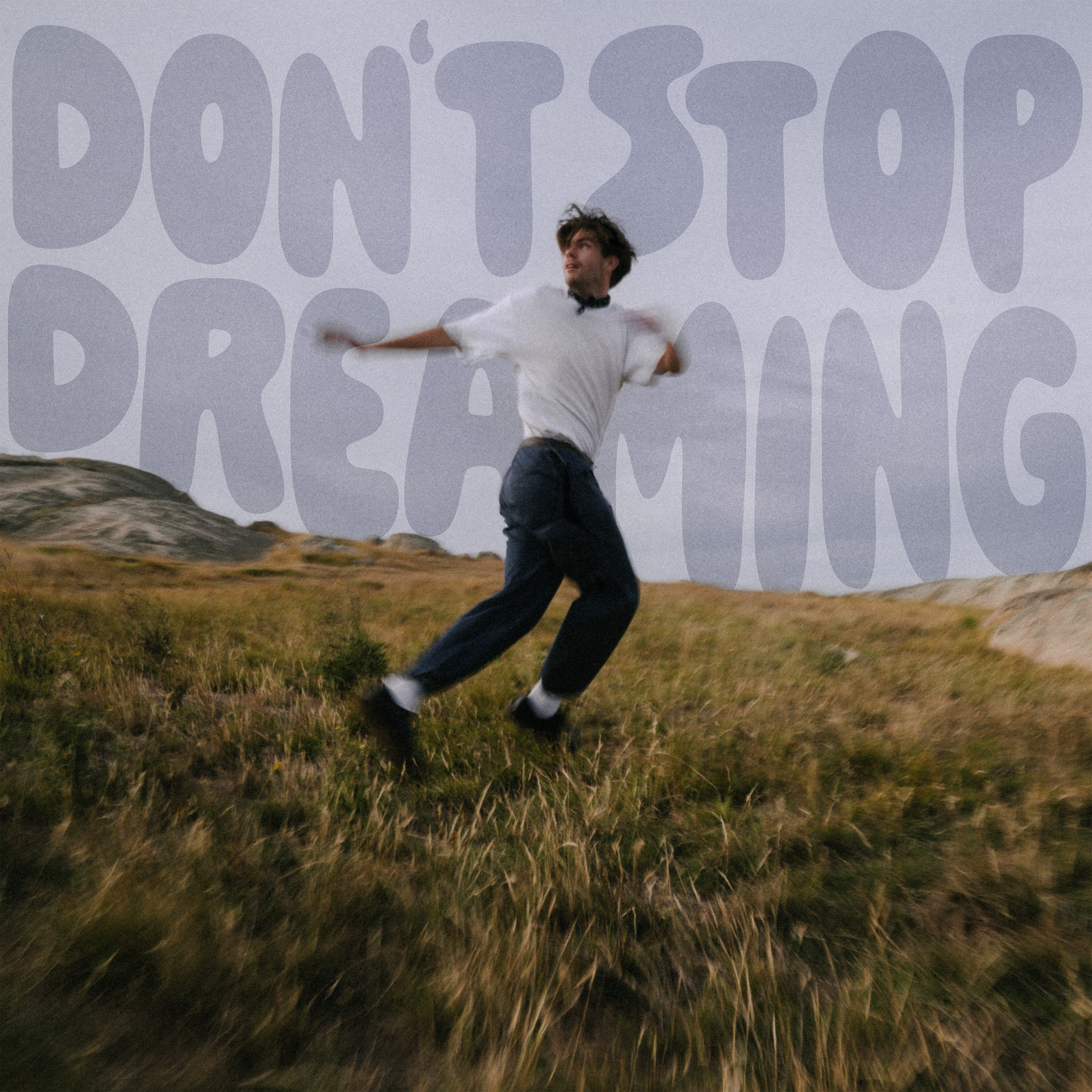 Person being swayed by the wind on a hill