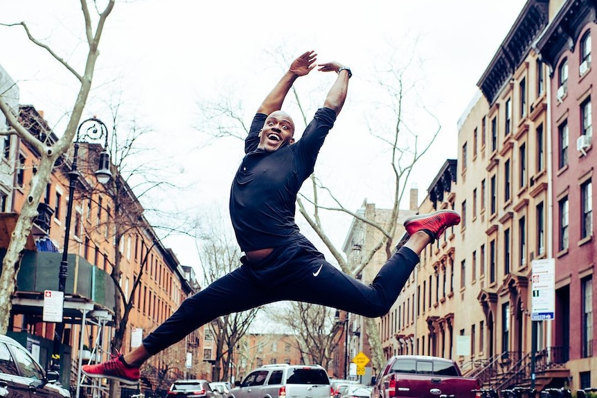 A man performs an acrobatic leap