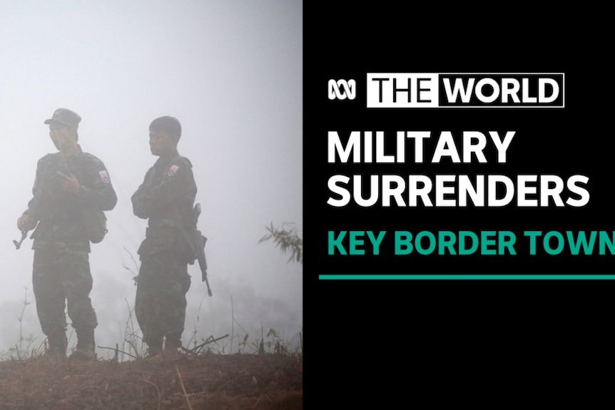 Military Surrenders, Key Border Town: Two soldiers stand on a hilltop shrouded in mist.