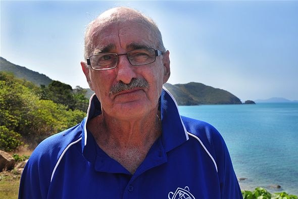 Jon Brodie standing on the shore with the north Queensland coast stretching out behind him