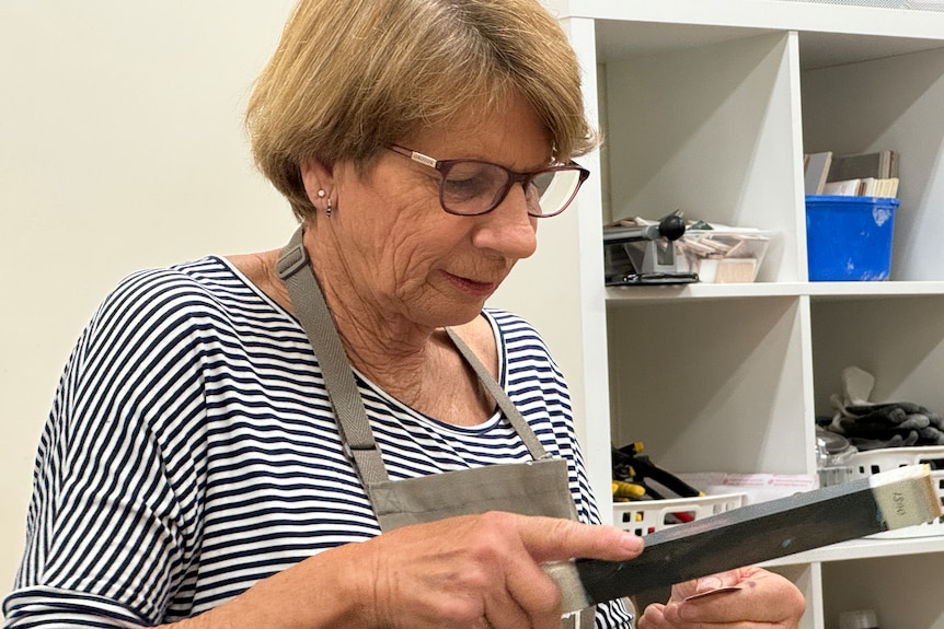 A woman holding tools