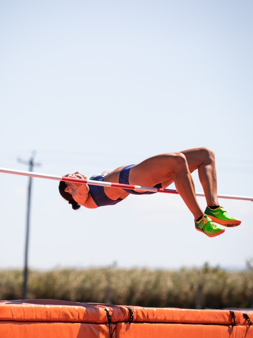 A woman clears a bar in high jump