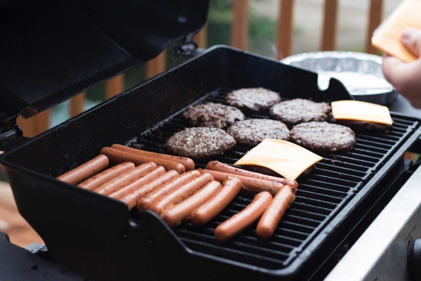 Sausages and hamburgers on a barbeque