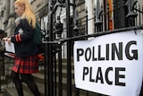 Young woman exits Scottish polls