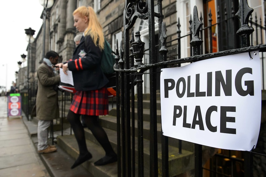 Young woman exits Scottish polls