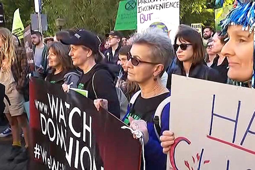 Extinction Rebellion protesters stand outside Queensland's Parliament House in Brisbane.