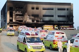 Ambulances queue outside the site of a fire in South Korea