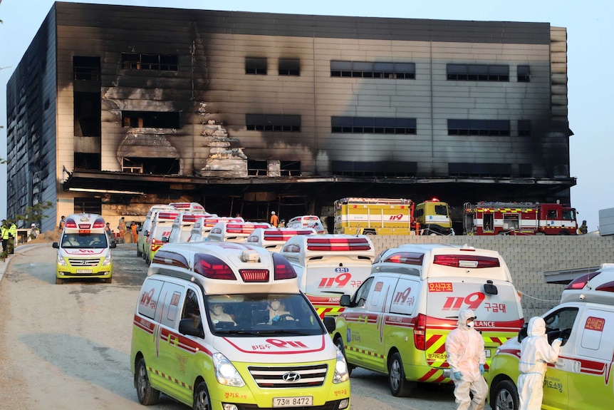 Ambulances queue outside the site of a fire in South Korea