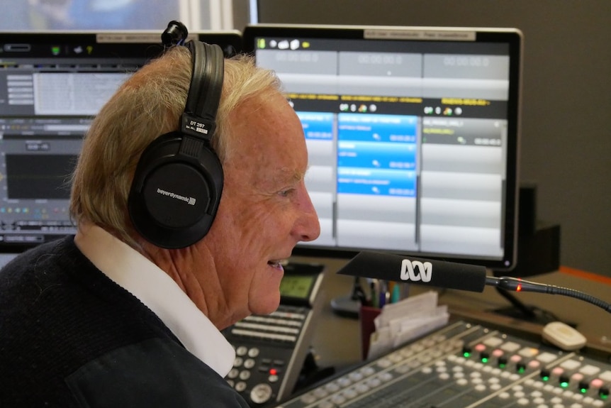 Profile shot of Pritchard wearing headphones in the ABC studio.