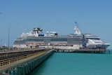 Image of a cruise ship docked at the end of a jetty in northern Australia.