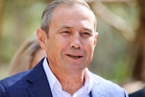 A head and shoulders shot of WA Deputy Premier Roger Cook dressed in a suit speaking outdoors.