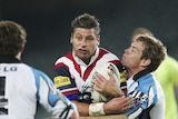 Roosters captain Luke Ricketson is tackled by Brett Kimmorley