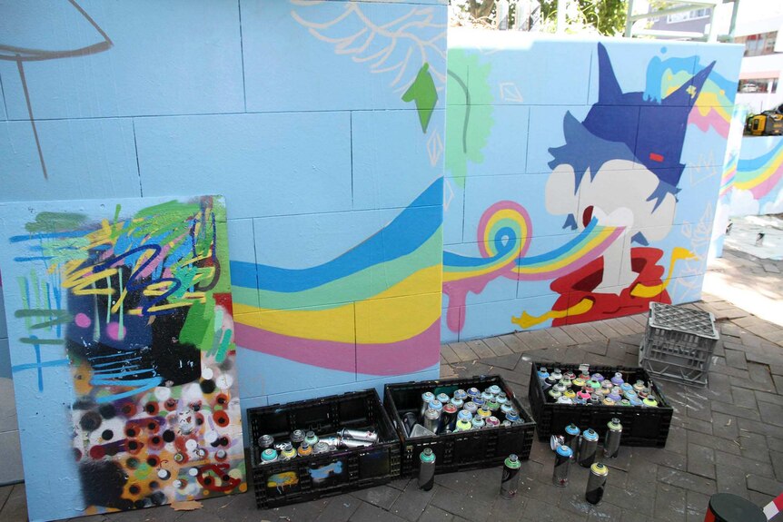 Three crates filled with paint in aerosol cans used to create the art work.