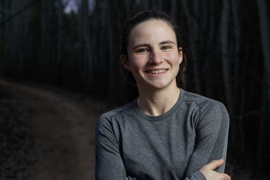 Portrait of a female running standing on a trail.