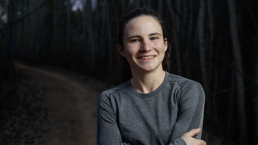 Portrait of a female running standing on a trail.