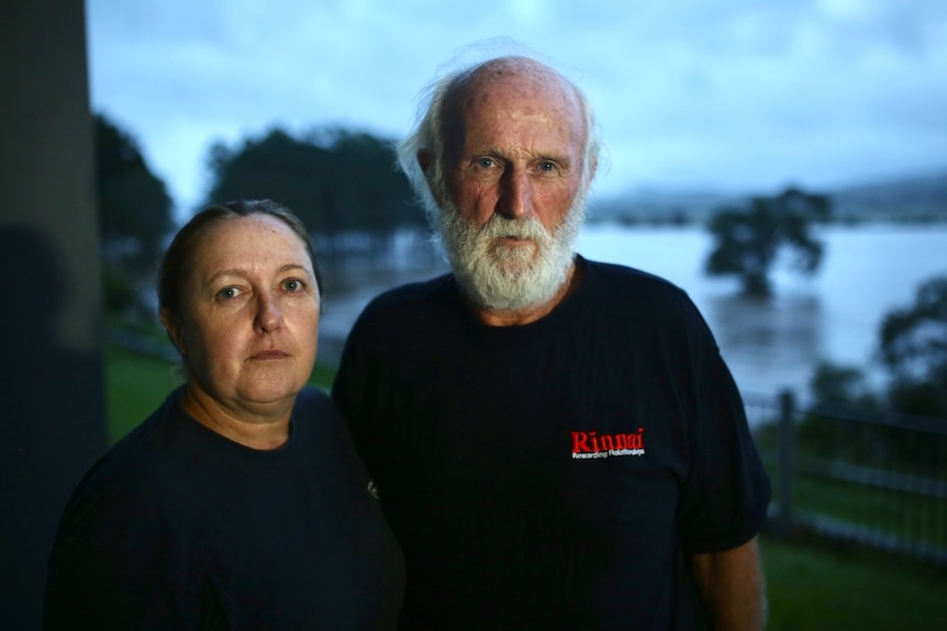 A woman and a man frown at the camera.