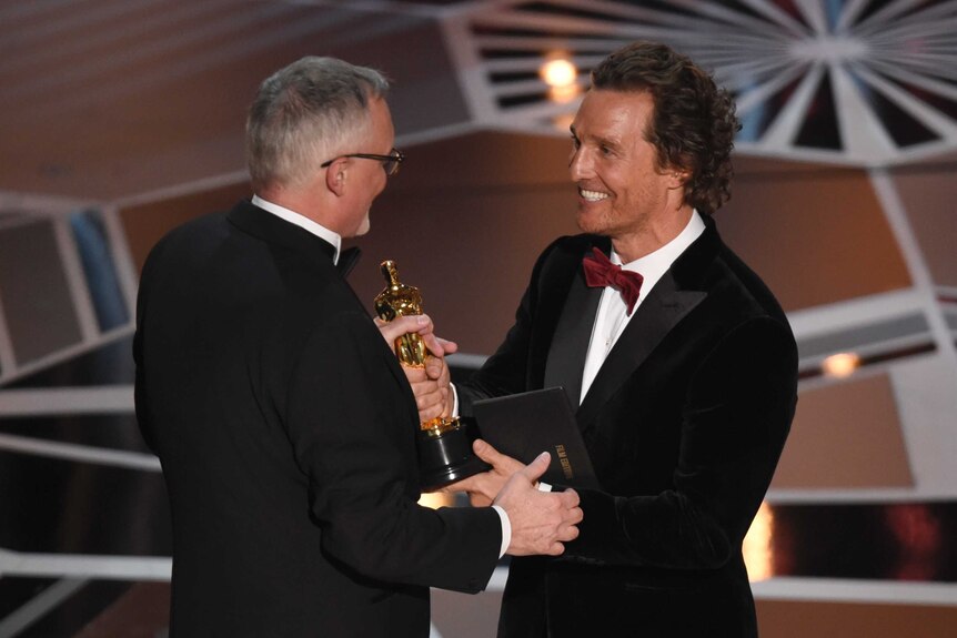 Matthew McConaughey presents Australian Lee Smith with the award for best film editing for Dunkirk.