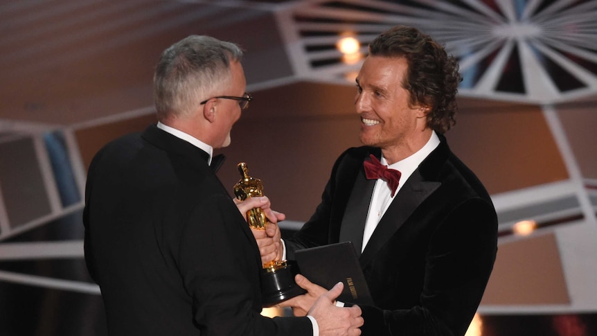 Matthew McConaughey presents Australian Lee Smith with the award for best film editing for Dunkirk.