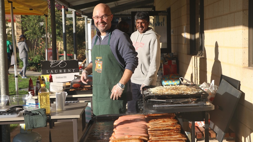 Volunteers cook the democracy sausages at Victoria Park Primary School