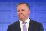 Australian Opposition Leader Anthony Albanese speaks stands behind lectern.