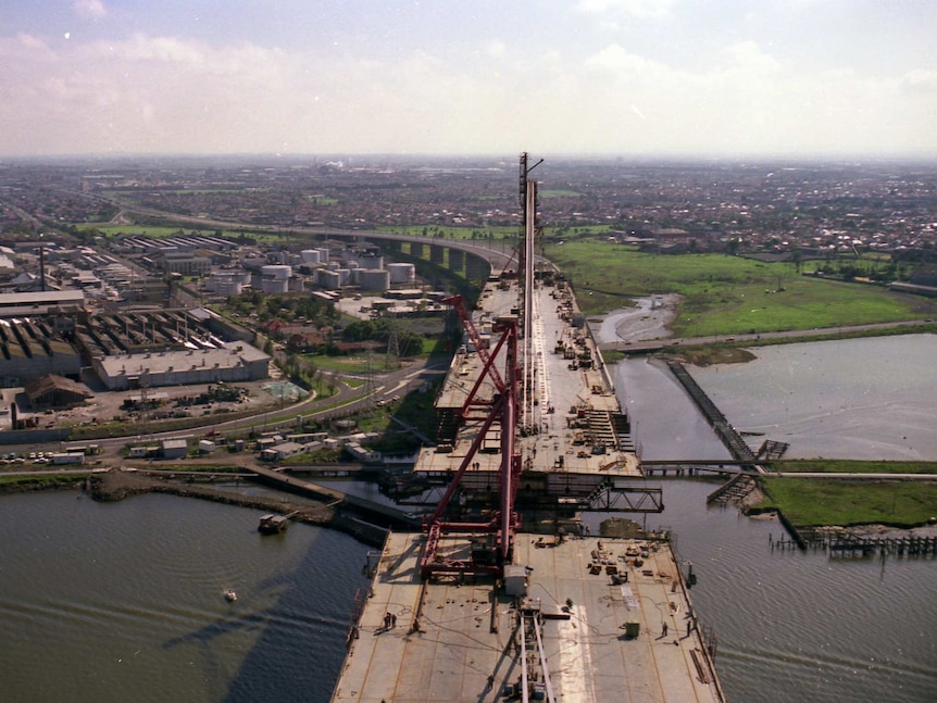 A photograph taken at the top of the partially built West Gate Bridge looking down to the Yarra River below.