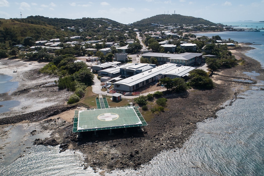 aerial of remote hospital near water