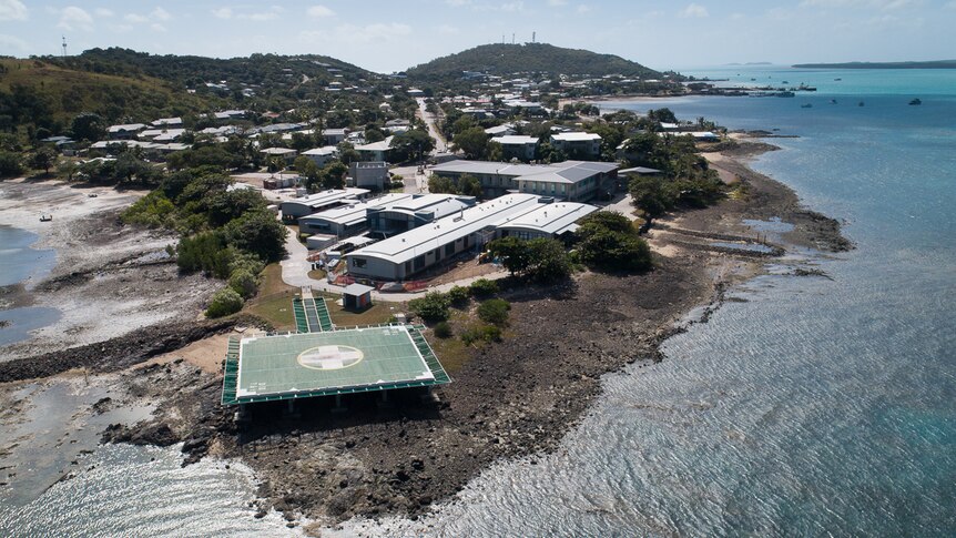 aerial of remote hospital near water