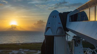SpaceX Dragon capsule on Falcon 9 rocket at dawn at Cape Canaveral