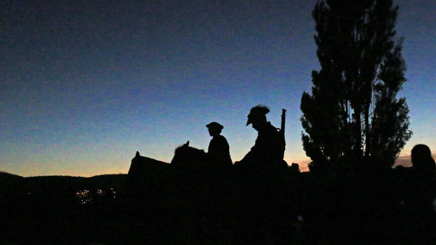 Soldiers on horses attend the Hobart Cenotaph Anzac Day service.