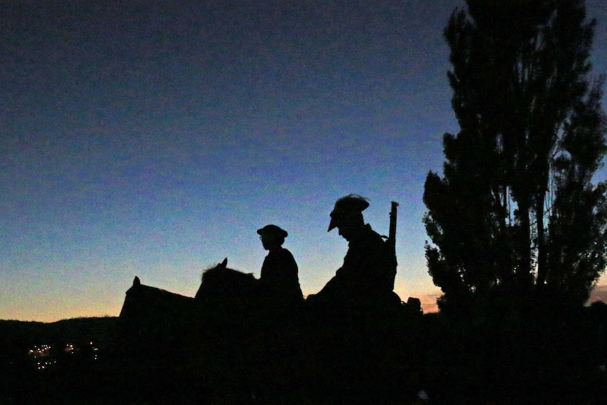 Soldiers on horses attend the Hobart Cenotaph Anzac Day service.