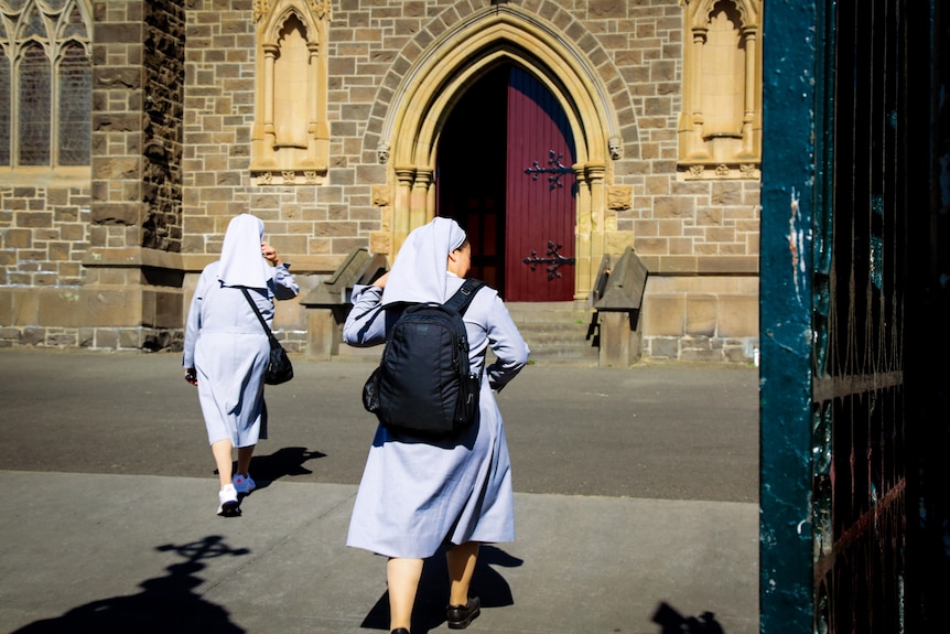 Two women dressed in a nun's habit enter St Patrick's cathedral in Ballarat. 