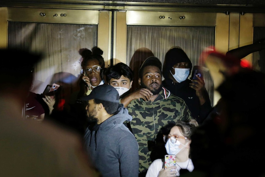 Police officers surround a group of people at Radio City Music Hall