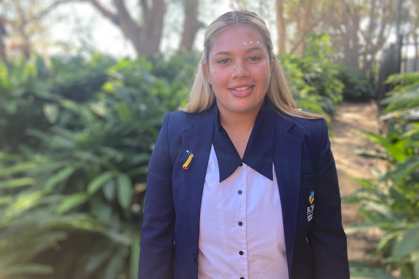 Indigenous teenage girl in a blue school blazer and white top