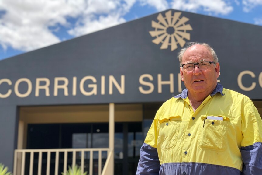 A man in a high-vis shirt stands in front of Corrigin Shire Council building