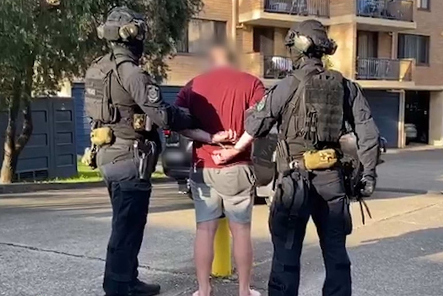 a man is arrested by tactical police
