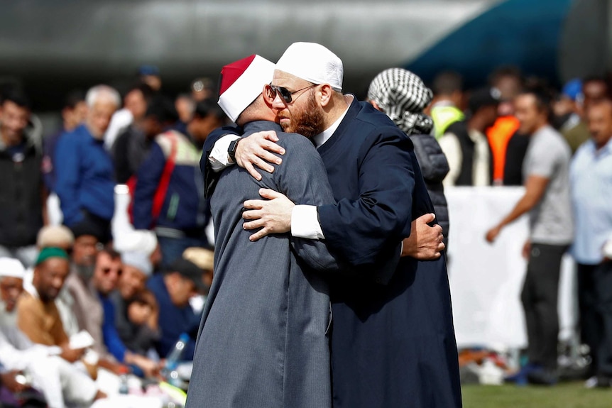 Two men hug at a memorial gathering after the Christchurch mosque attack.